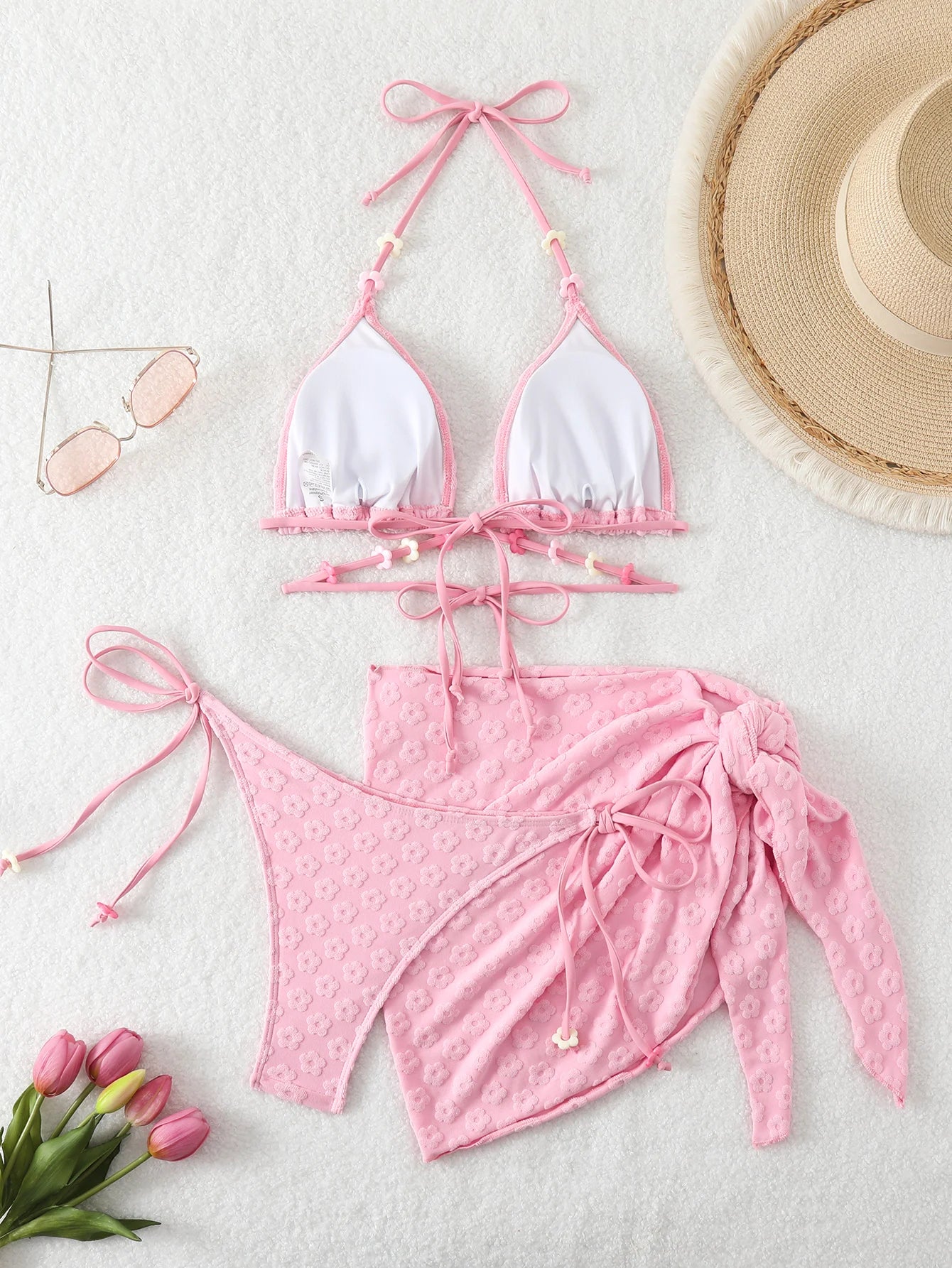 Bikini set for women with a skirt style towel fabric and romantic floral accessories.