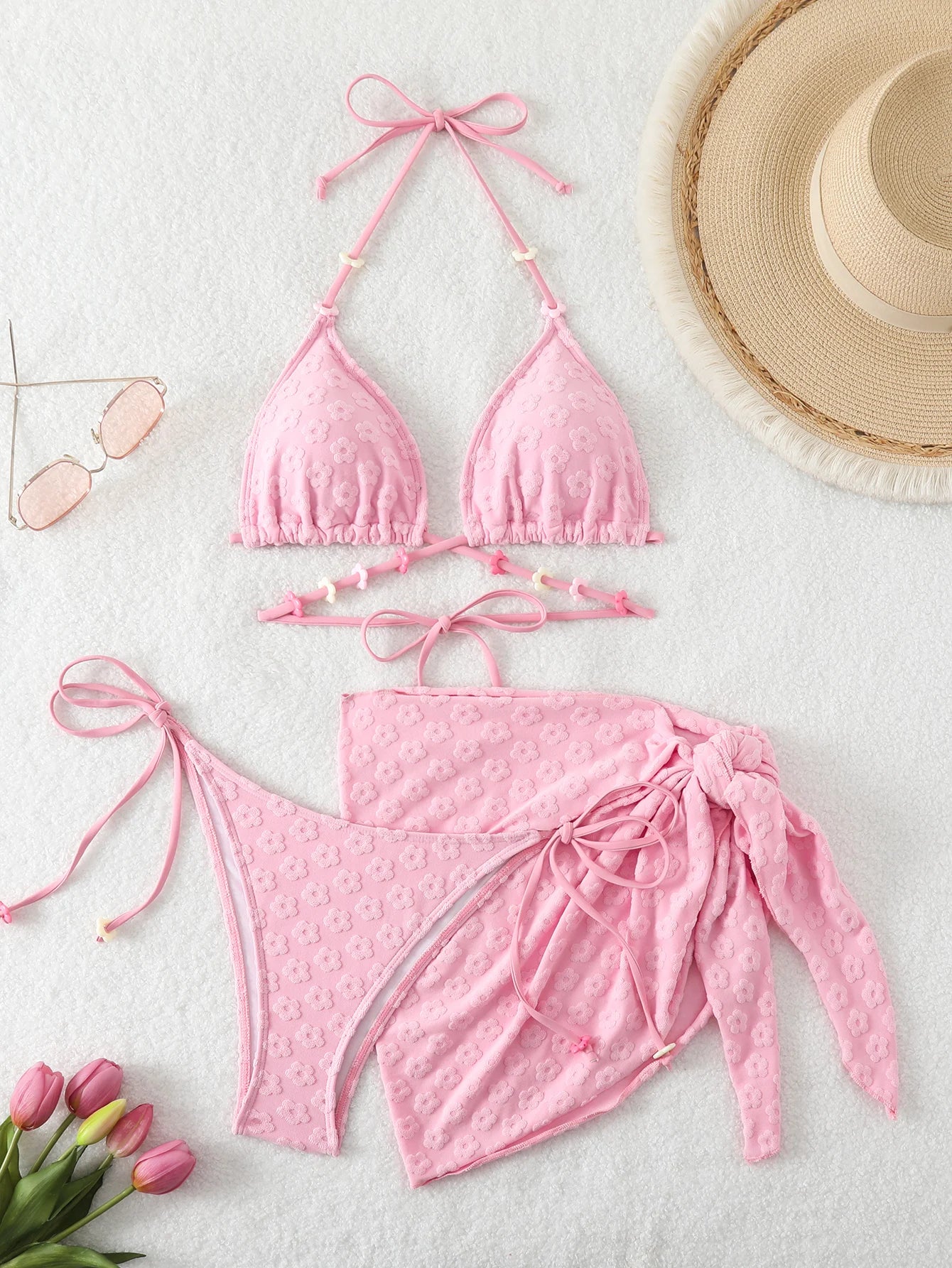 Bikini set for women with a skirt style towel fabric and romantic floral accessories.